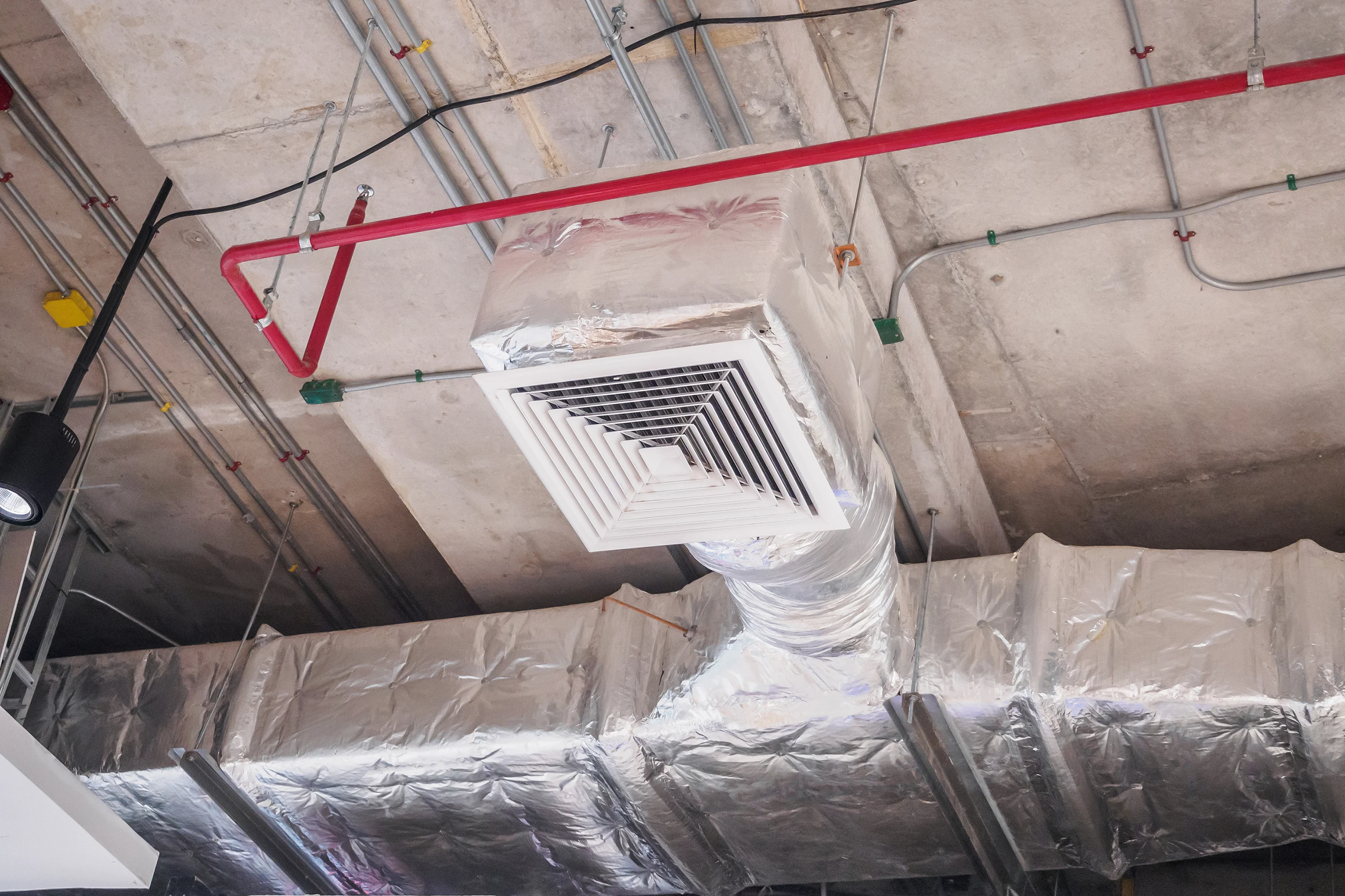 AC TO THE MAX, INC technician evaluating airflow for ductwork repair.